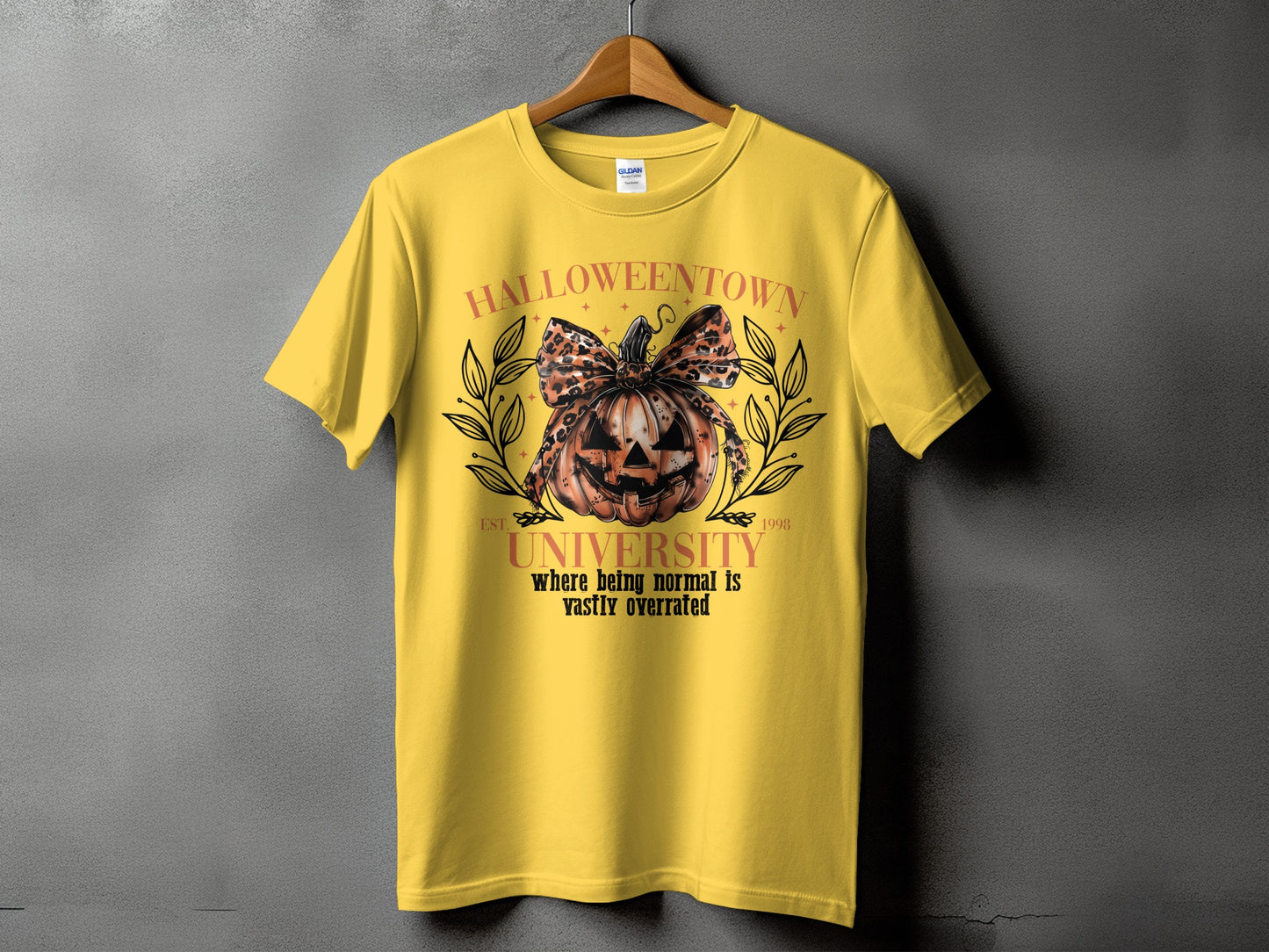 Yellow t-shirt with "Halloweentown University" graphic and pumpkin.