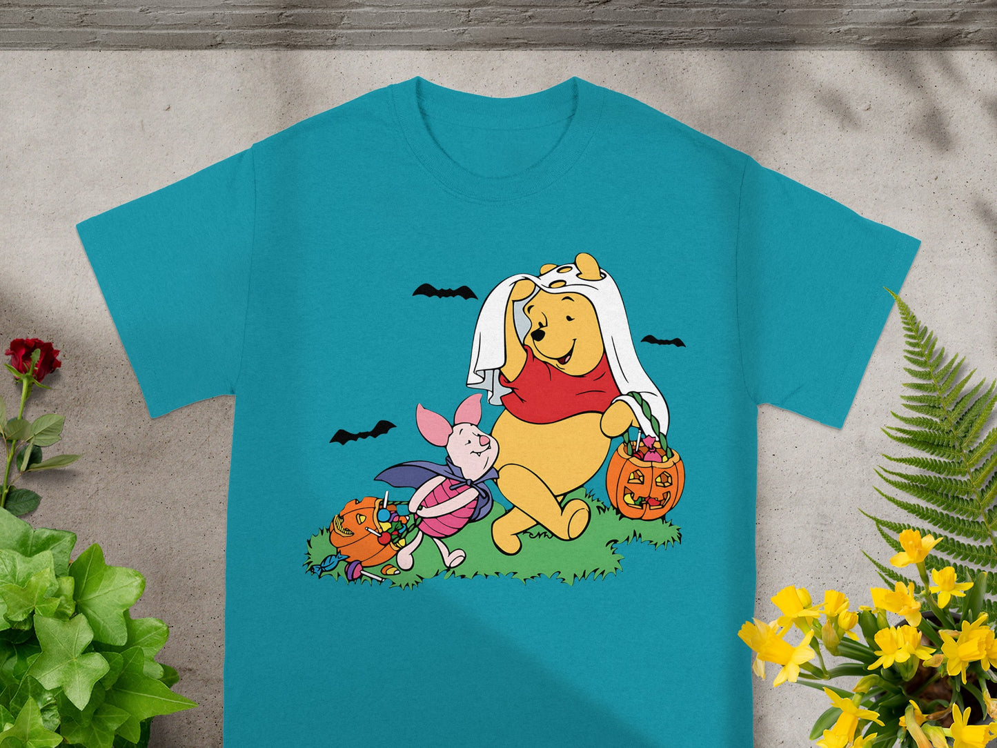 Winnie the Pooh and Piglet in Halloween costumes with pumpkins and candy.