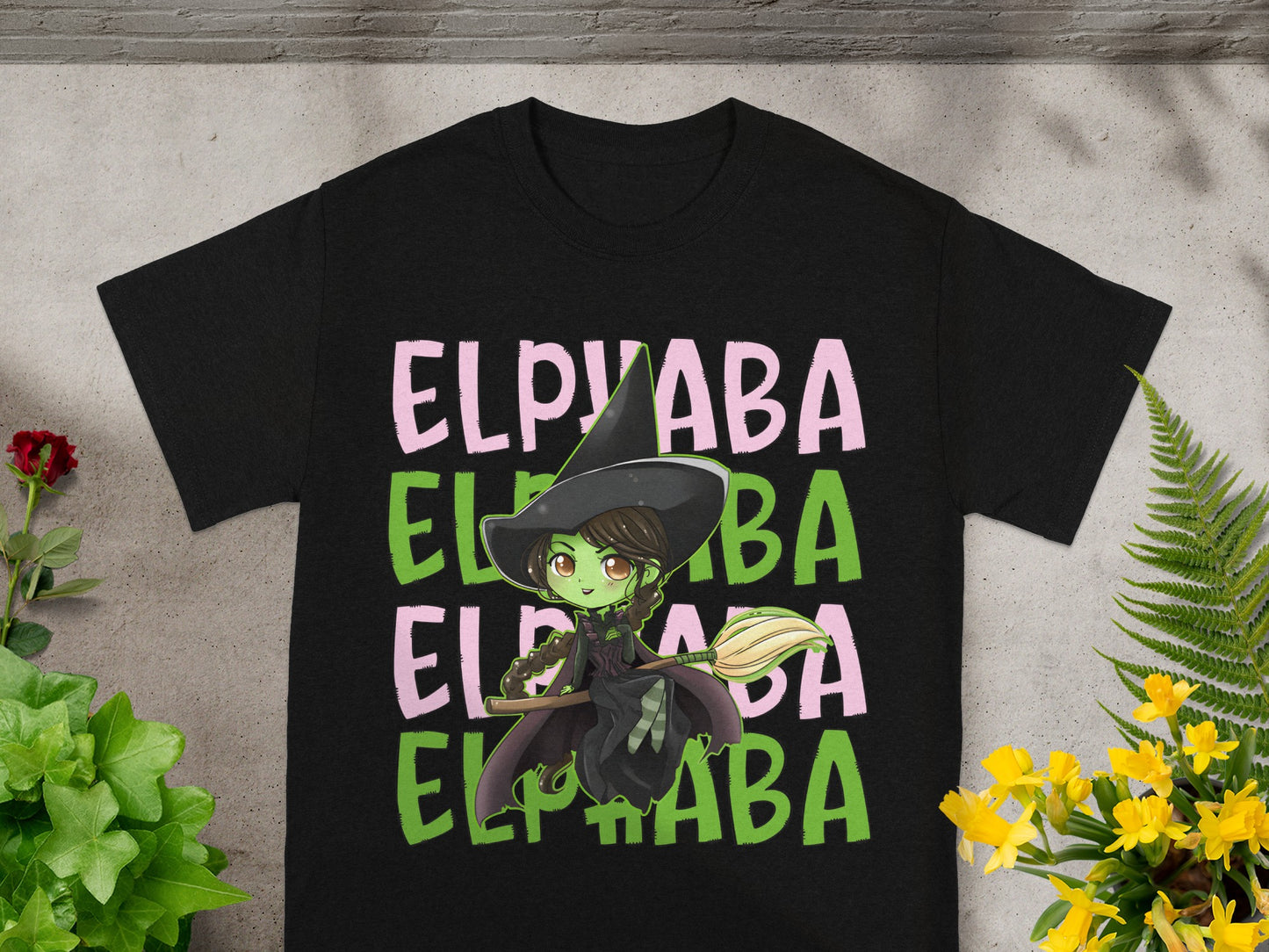 Black t-shirt with green witch graphic and "ELPVABA" text.