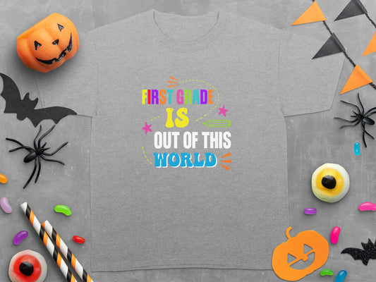 Grey t-shirt with "First Grade Is Out Of This World" text surrounded by Halloween decorations.