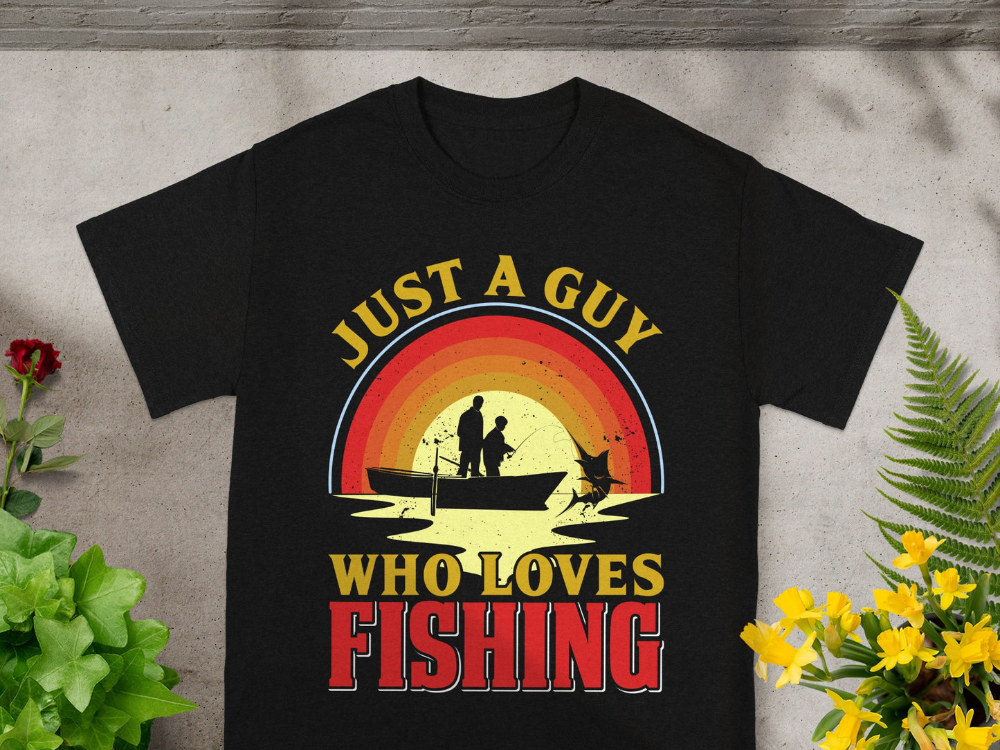 Black t-shirt with "JUST A GUY WHO LOVES FISHING" text and fishing graphic.