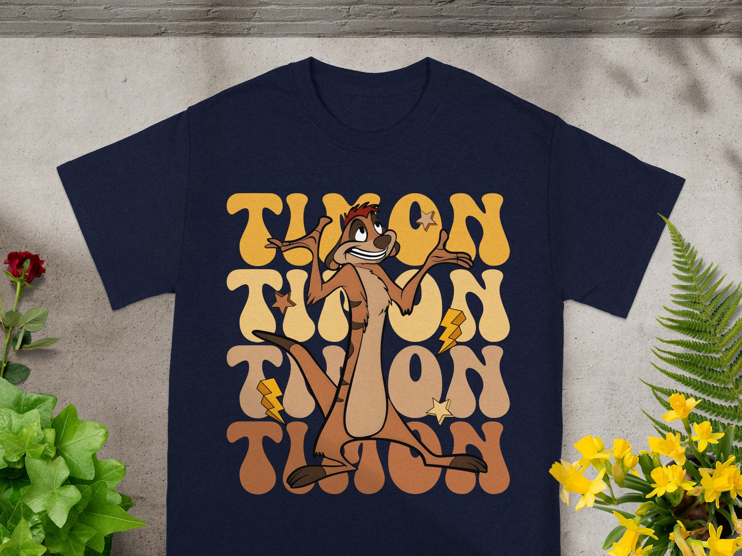Navy t-shirt with "TIMON" in large wavy text and a cartoon meerkat.