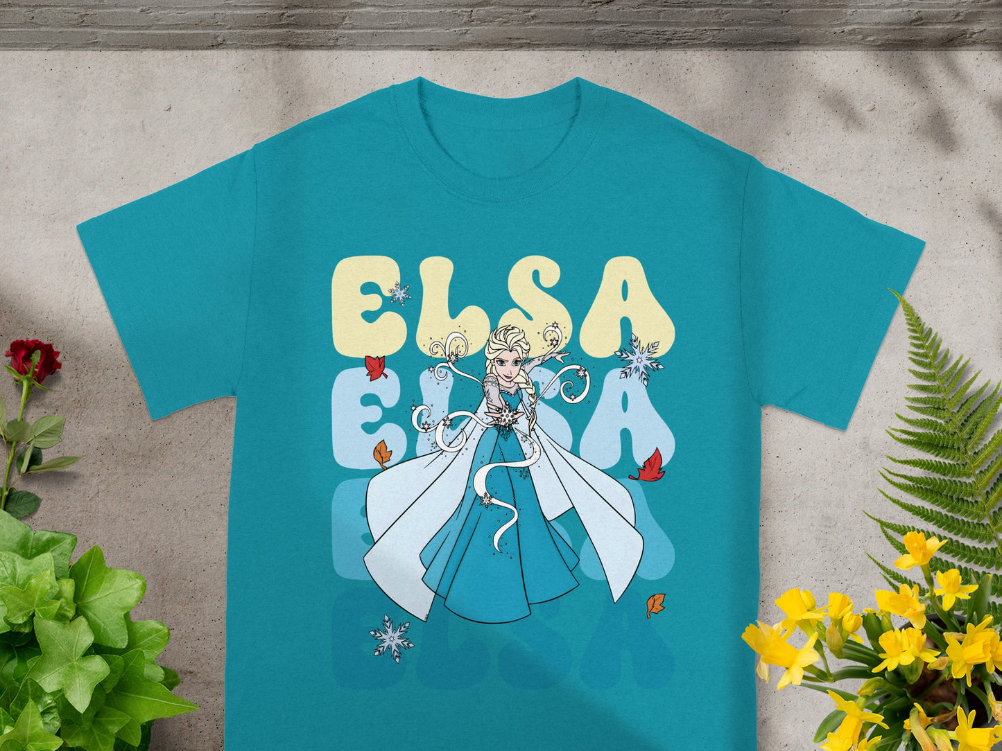 Teal t-shirt with Elsa and text "ELSA" in large blue letters.