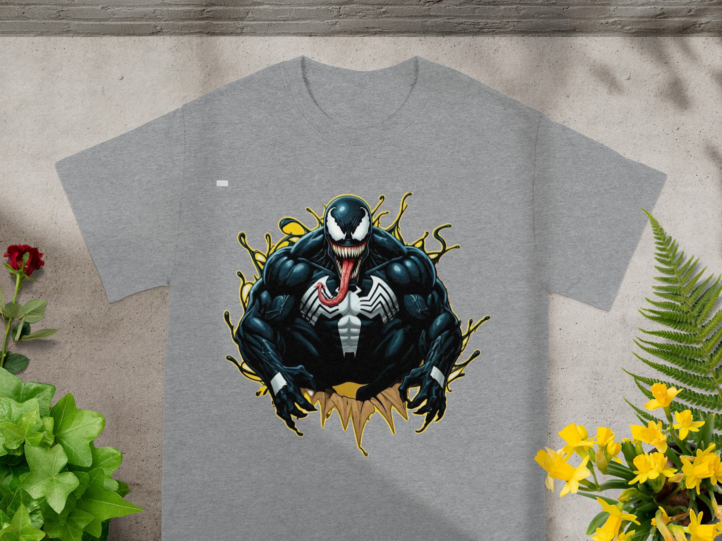 Venom character graphic on a grey t-shirt with yellow splatters.