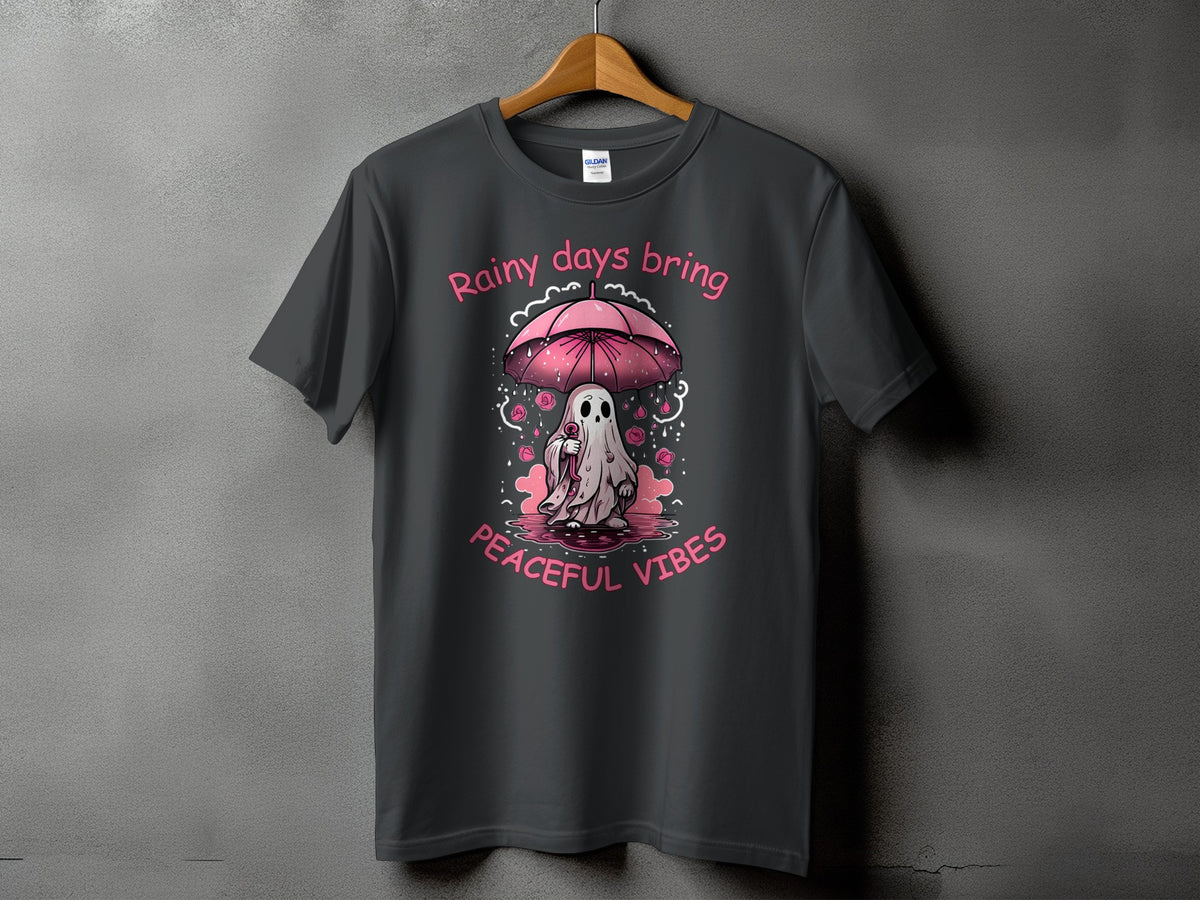 Dark gray t-shirt with pink text "Rainy days bring peaceful vibes" and a ghost under an umbrella.