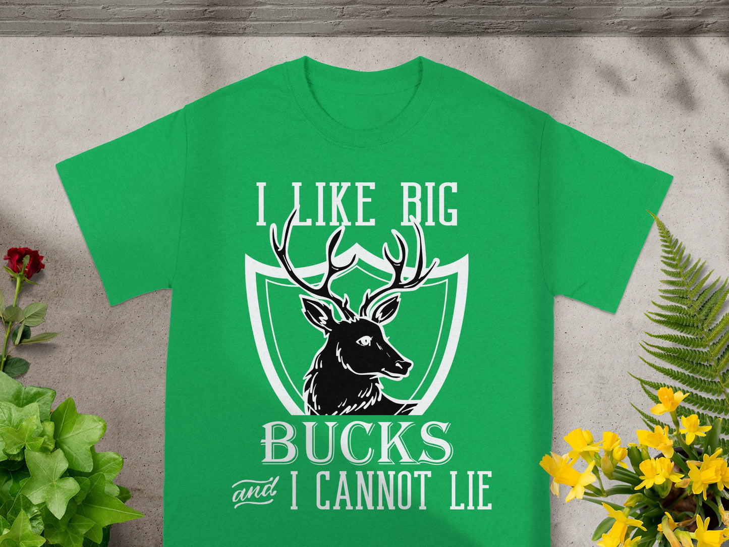 Green t-shirt with white text "I LIKE BIG BUCKS and I CANNOT LIE" and deer graphic.