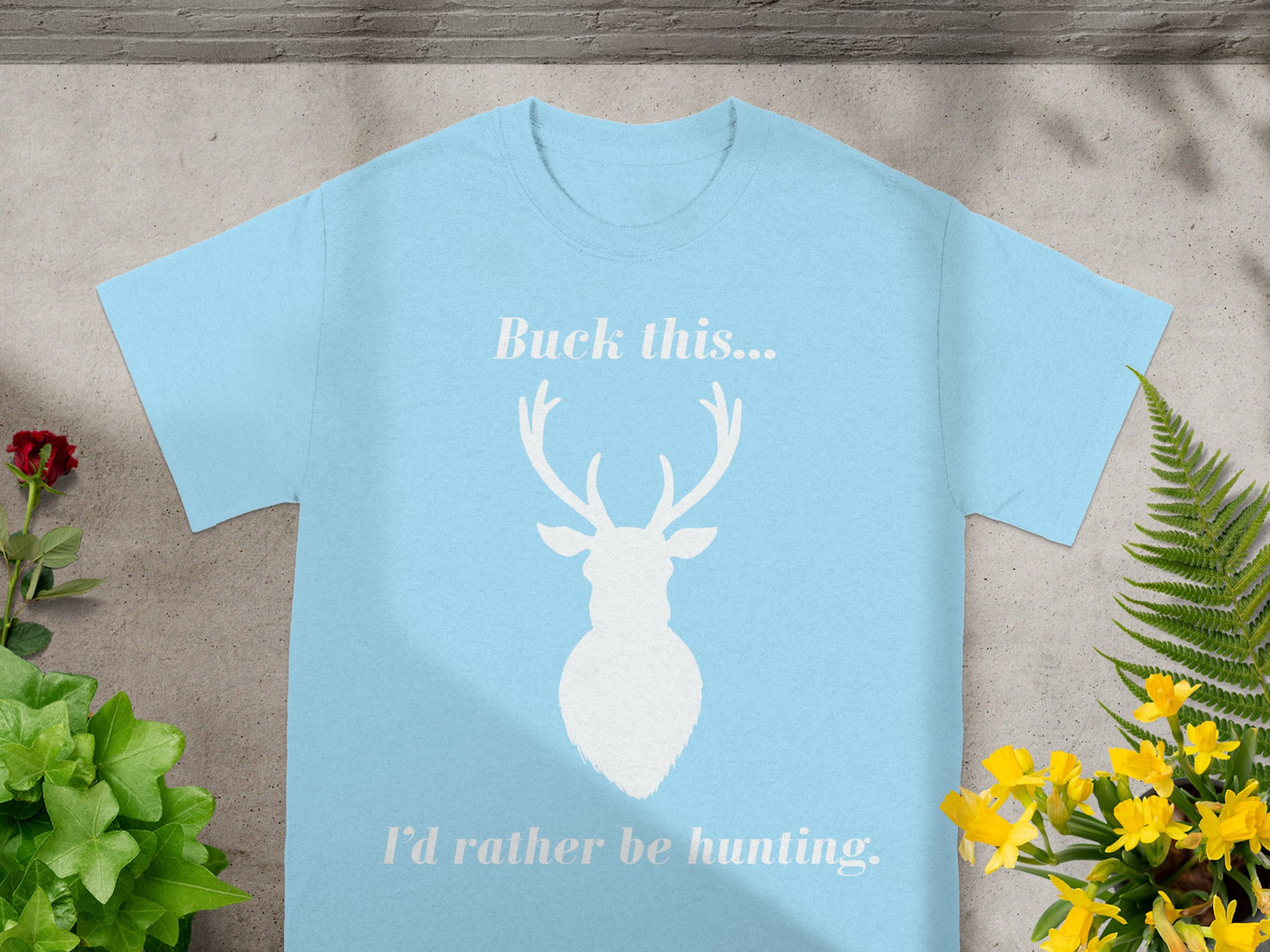 Light blue t-shirt with white deer silhouette and text reading "Buck this... I'd rather be hunting."
