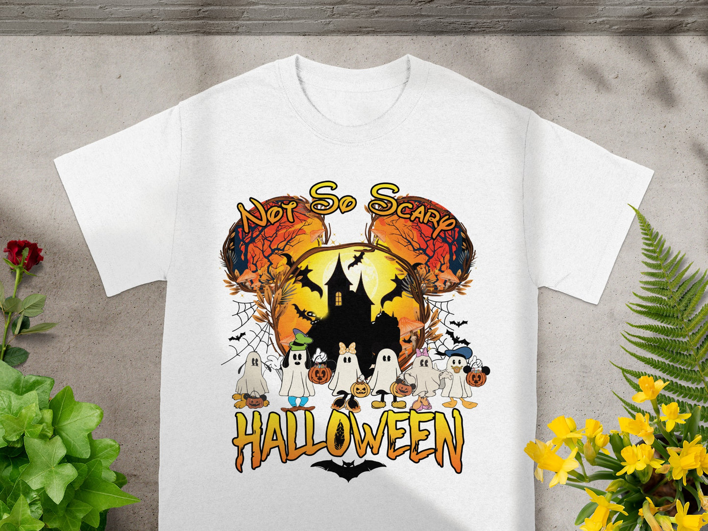 White t-shirt with Halloween graphic featuring ghosts and Mickey Mouse ears with text "Not So Scary Halloween."