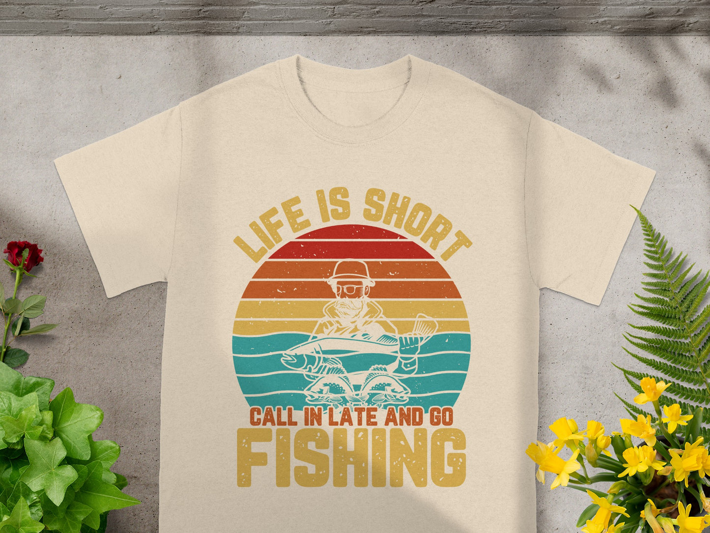 T-shirt graphic with fisherman holding fish, "Life Is Short Call In Late And Go Fishing".