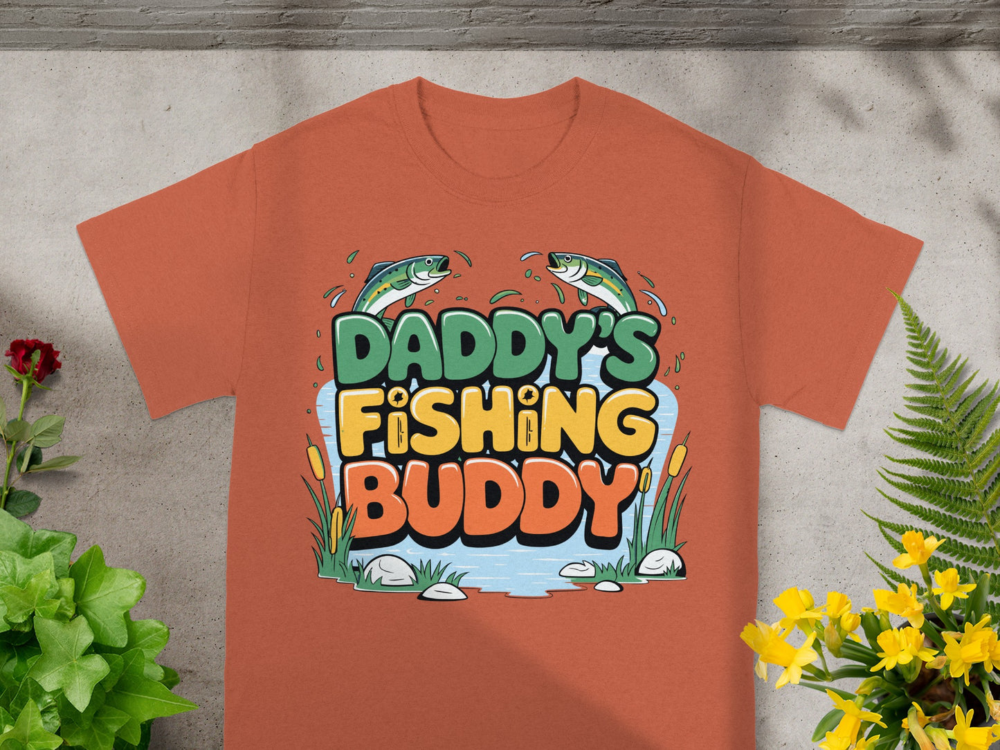 Orange t-shirt with "Daddy's Fishing Buddy" text and two fish.