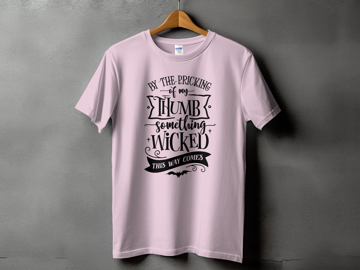 Light pink t-shirt with black text "By the pricking of my thumb something wicked this way comes".