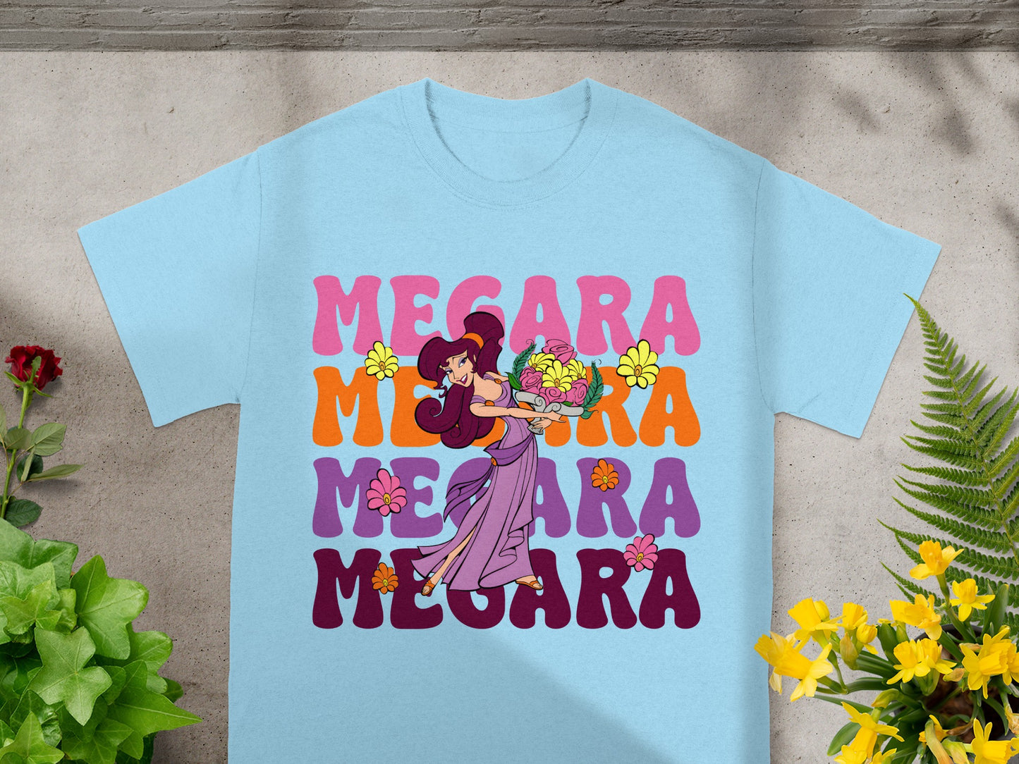 Light blue t-shirt with "MEGARA" in colorful text and floral accents.