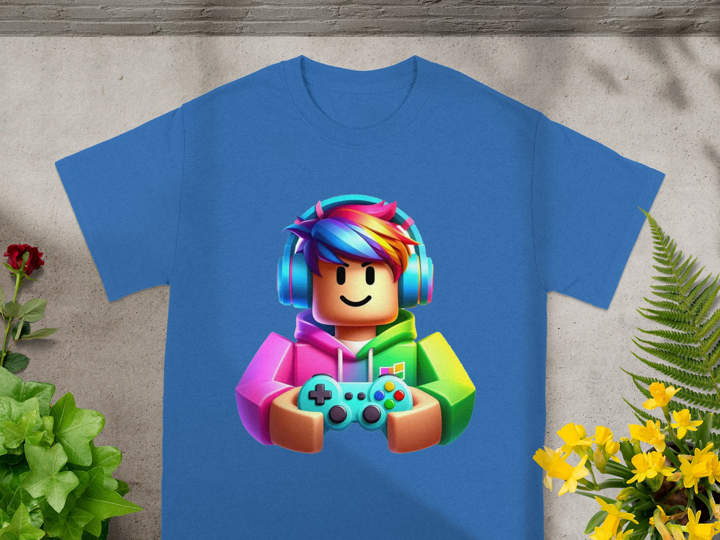 Blue t-shirt with Roblox character in colorful headphones and holding a game controller.
