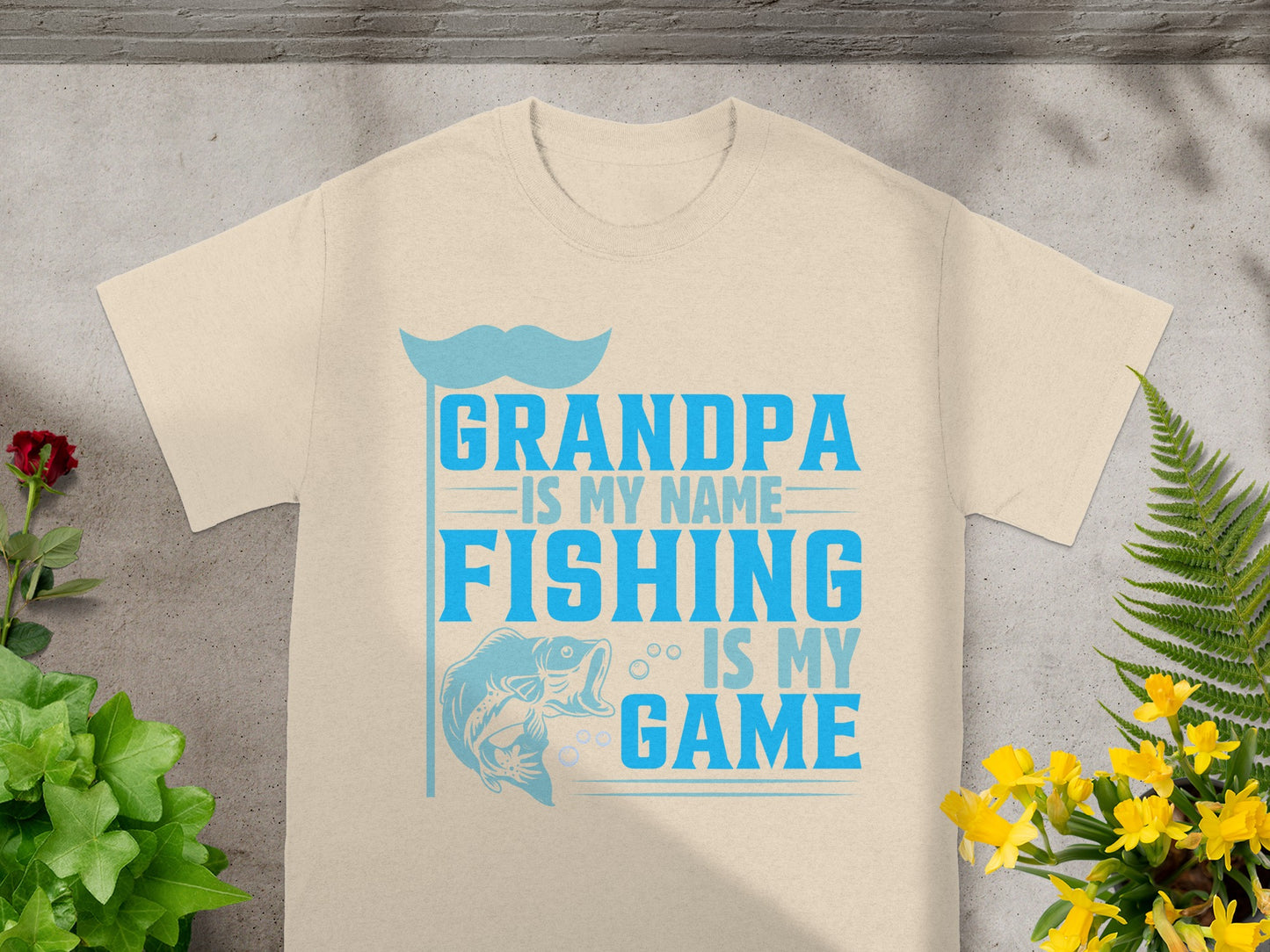 "Grandpa is my name, fishing is my game" t-shirt with fish graphic.