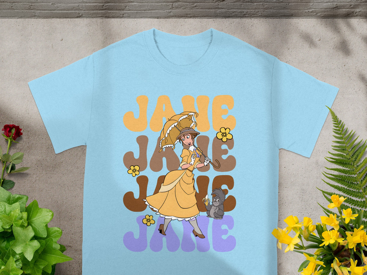 Light blue t-shirt with "JANE" in retro font and animated character holding an umbrella.