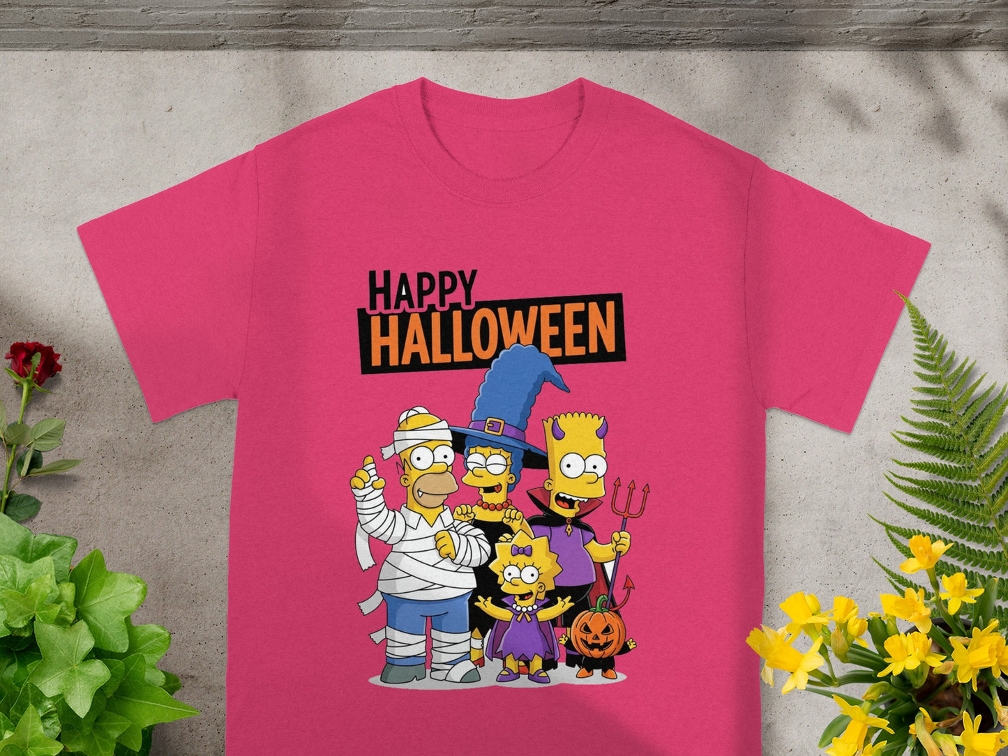 The Simpsons characters in Halloween costumes on a pink t-shirt with text "Happy Halloween."