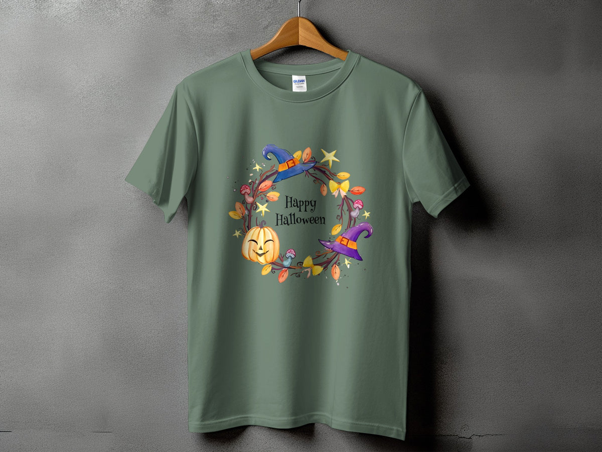 Green t-shirt with a Halloween wreath featuring a smiling pumpkin, witch hats, and leaves.