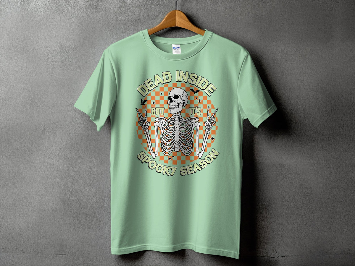 Light green t-shirt with a skeleton graphic that reads "DEAD INSIDE BUT IT'S SPOOKY SEASON".