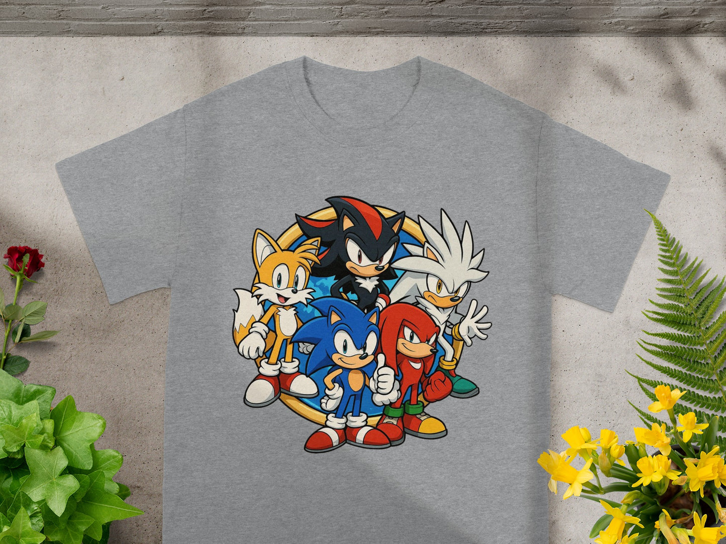 Sonic the Hedgehog characters including Sonic, Tails, Knuckles, and Shadow on a grey t-shirt.