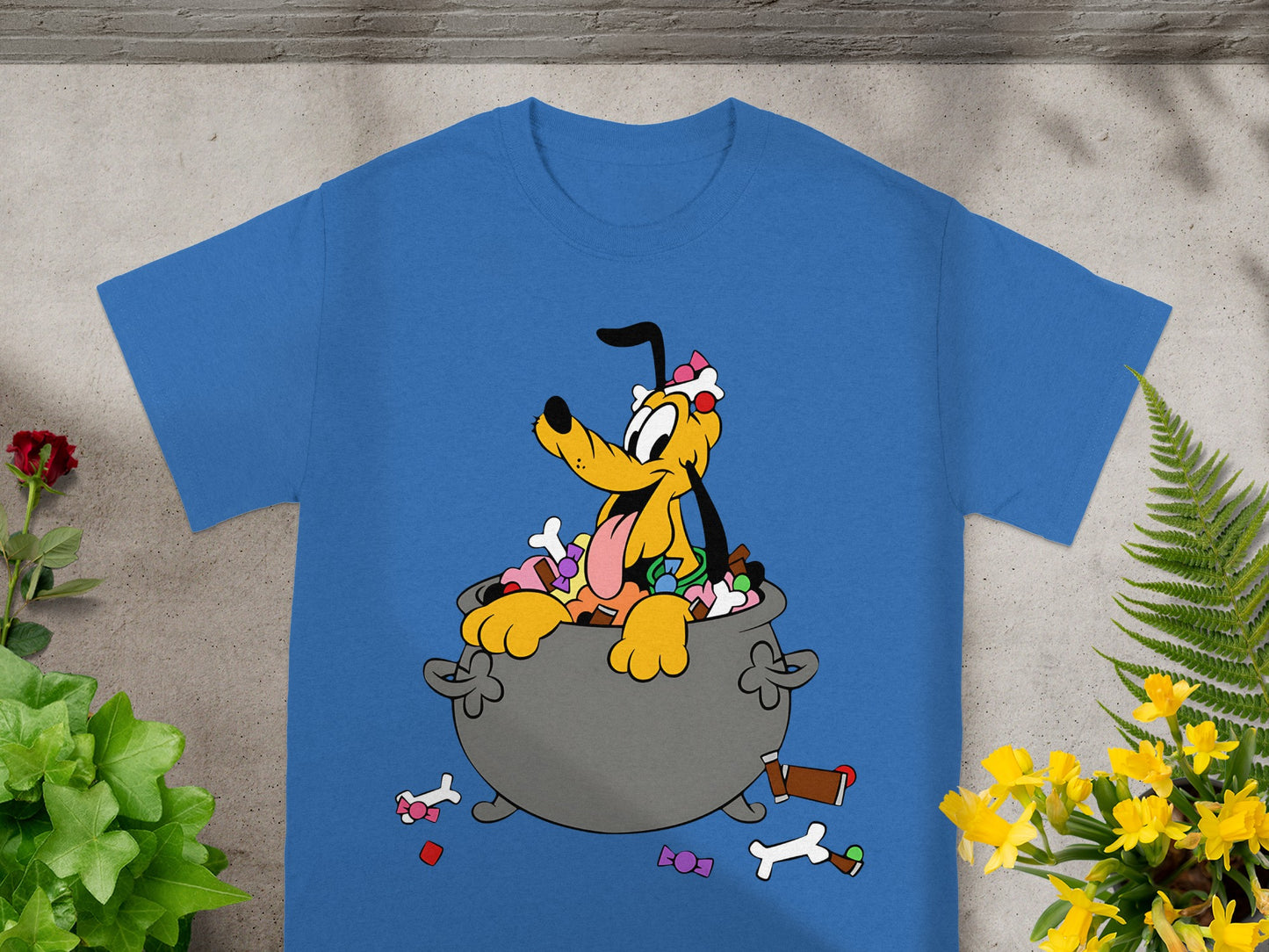 Pluto character sitting in a cauldron filled with candy and scattered bones.
