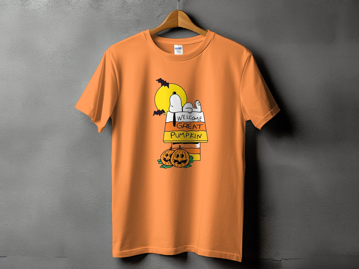 Orange t-shirt with Snoopy, pumpkins, bats, and "Welcome Great Pumpkin" text.