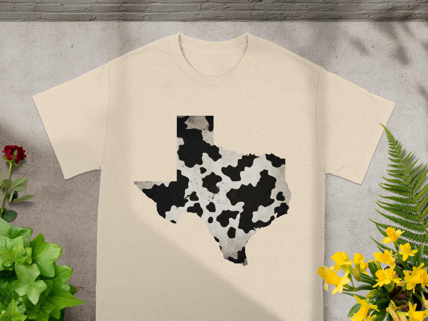 Tan t-shirt with Texas map graphic in cowhide print pattern.
