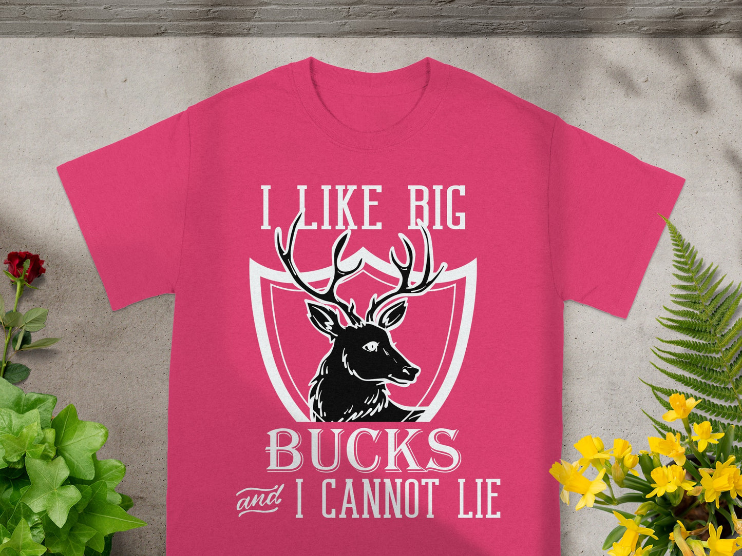 Pink t-shirt with graphic of deer head and text "I LIKE BIG BUCKS and I CANNOT LIE".