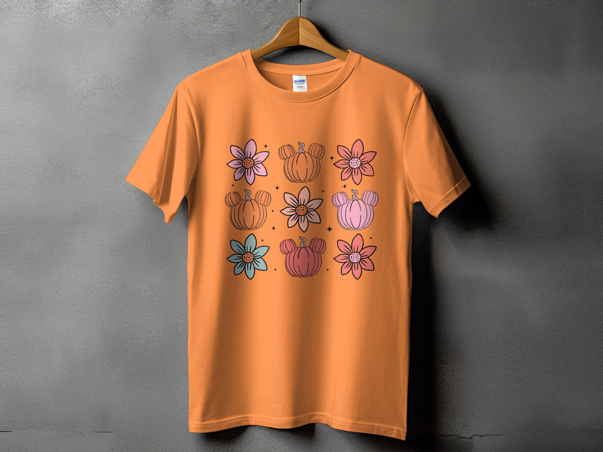Orange t-shirt with a grid of pastel flowers and Mickey-shaped pumpkins.