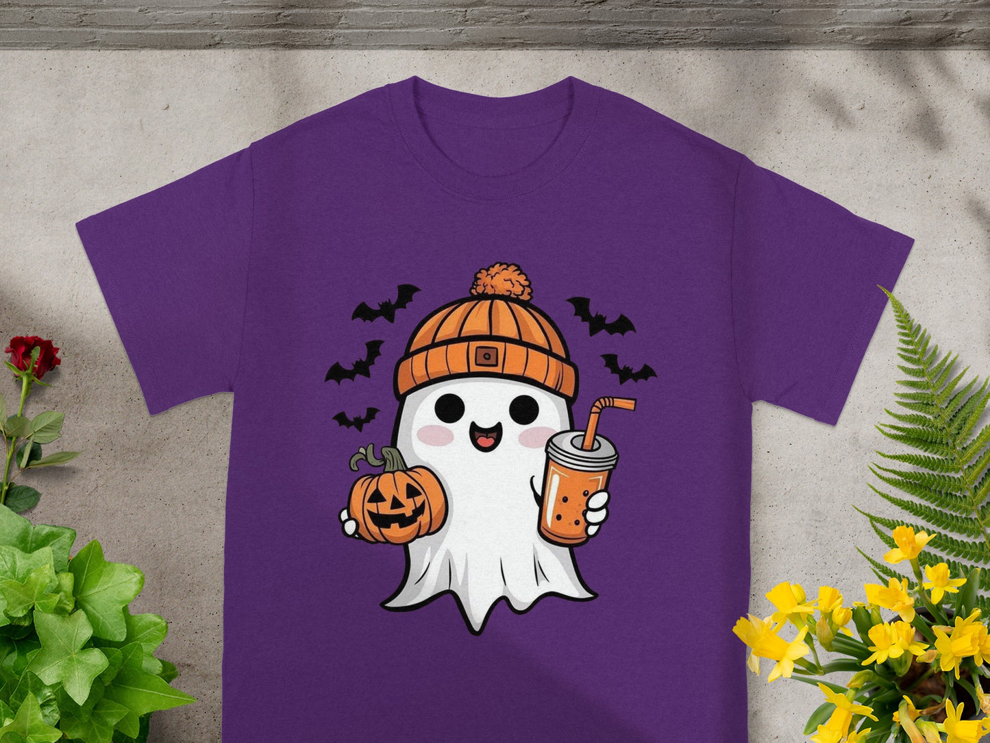 Cute ghost with pumpkin and drink on purple t-shirt, with bats.