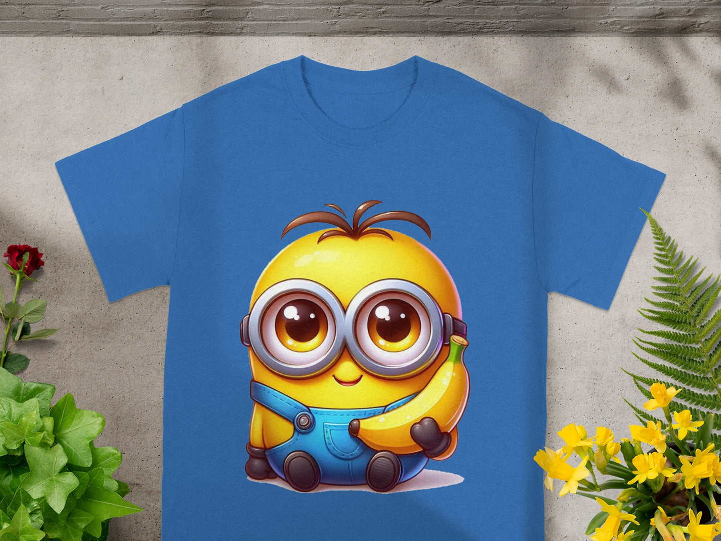 Blue t-shirt with a cartoon Minion character holding a banana.