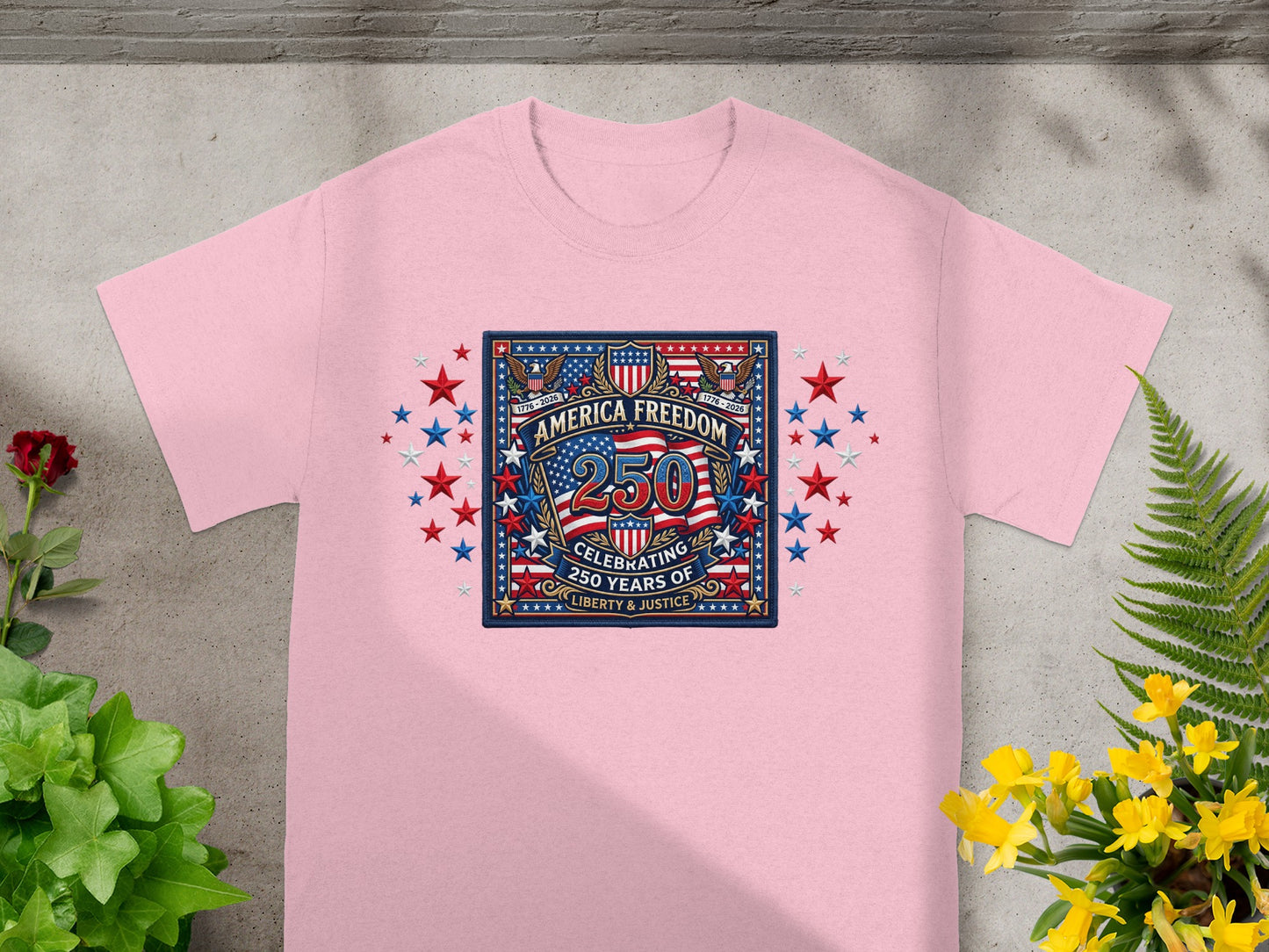 Pink t-shirt with "America Freedom" 250th anniversary logo featuring stars and stripes.