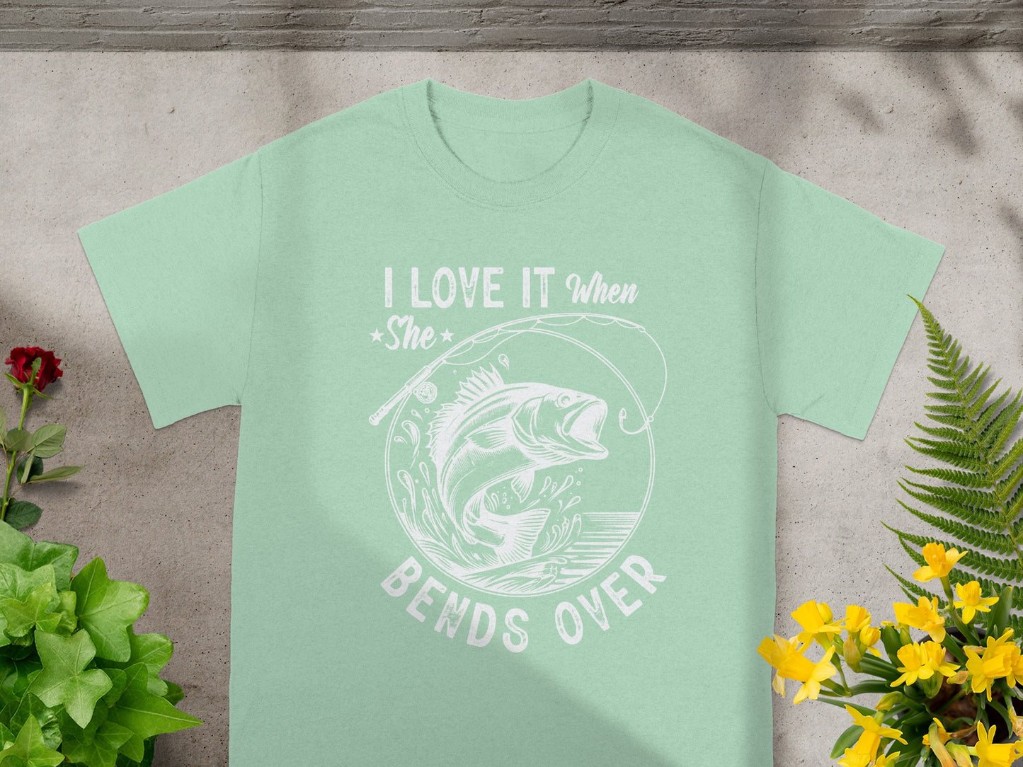 Light green t-shirt with white text and a fish graphic, "I LOVE IT When *She* BENDS OVER".