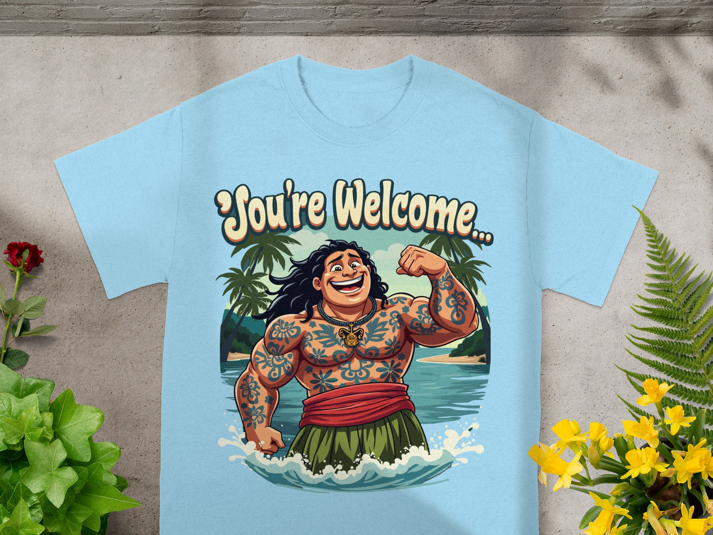 Light blue t-shirt with a cartoon man with tattoos saying "You're Welcome".