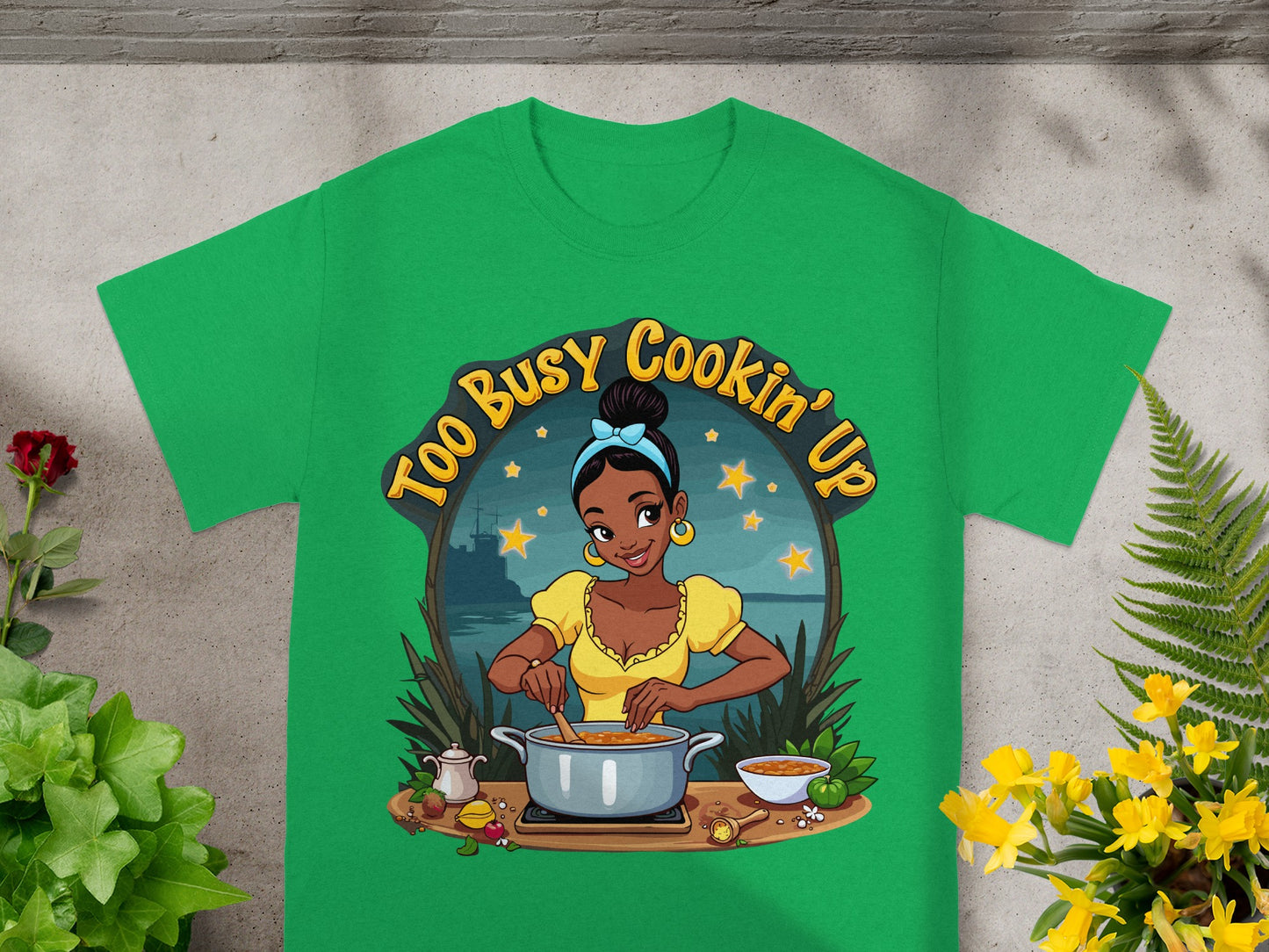 Green t-shirt with illustration of a Black woman cooking.