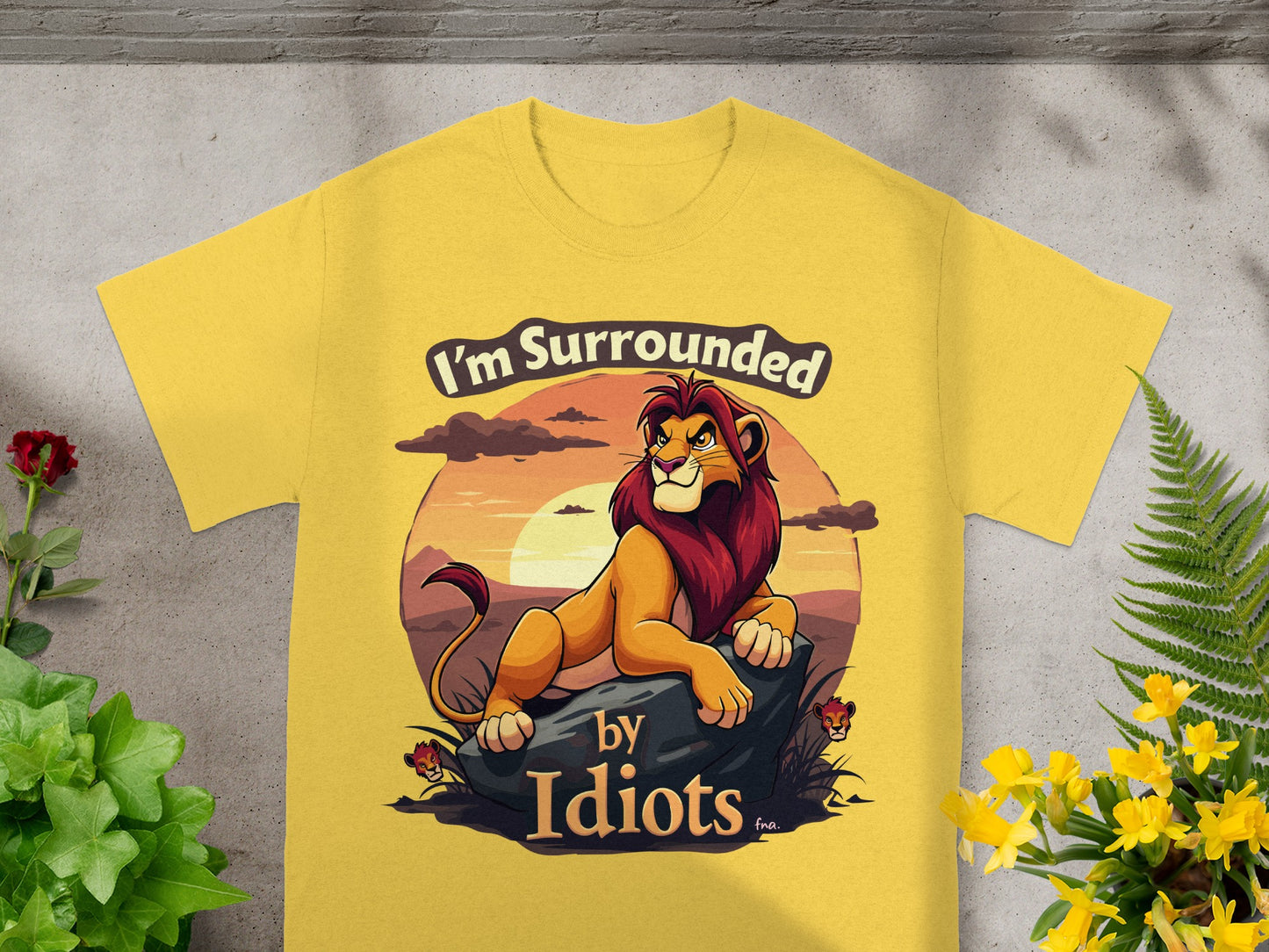 Yellow t-shirt with lion graphic and "I'm Surrounded by Idiots" text.