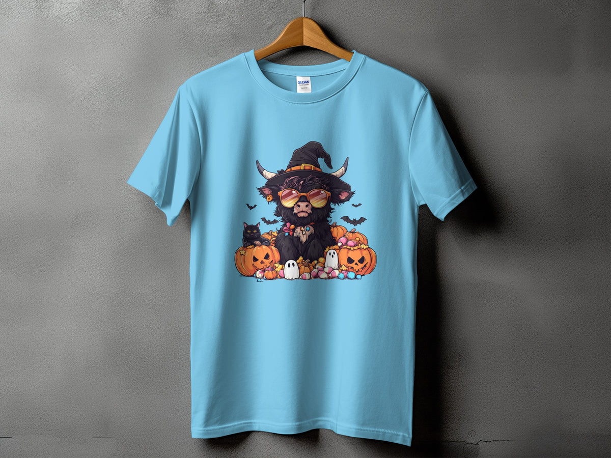 T-shirt with a cartoon highland cow wearing a witch hat, sunglasses, and surrounded by pumpkins.