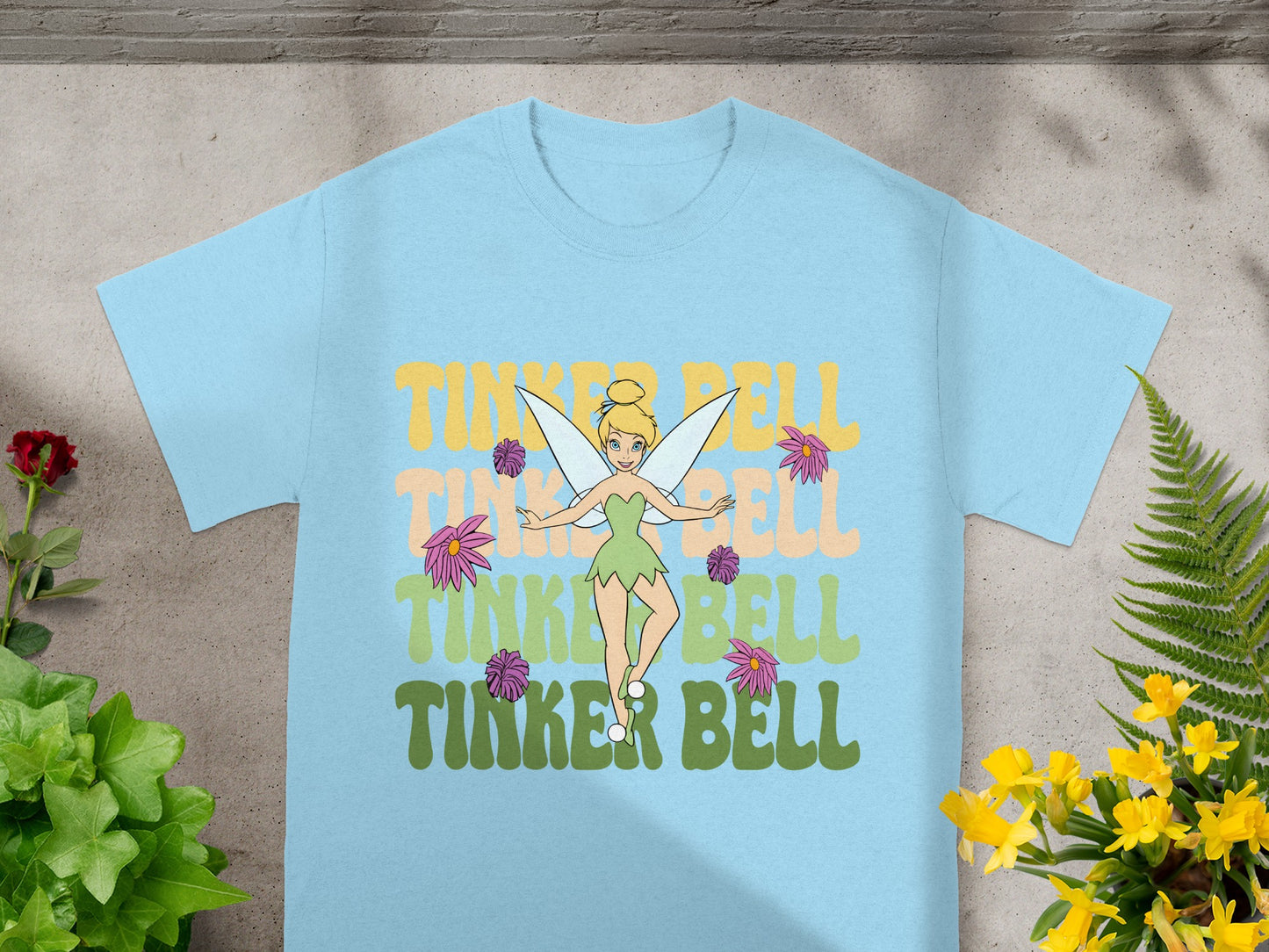 Light blue t-shirt with "Tinker Bell" text and fairy graphic.