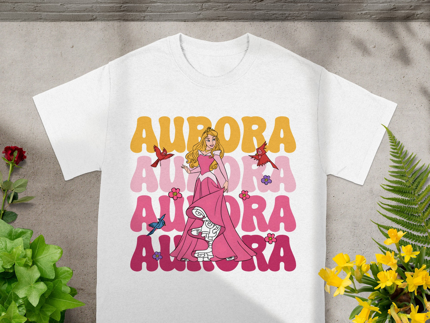 White t-shirt with Aurora and birds graphic.