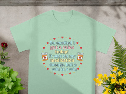 Mint t-shirt with "So excited I got a raise today! It was on my medication dosage, but a win is a win" text.