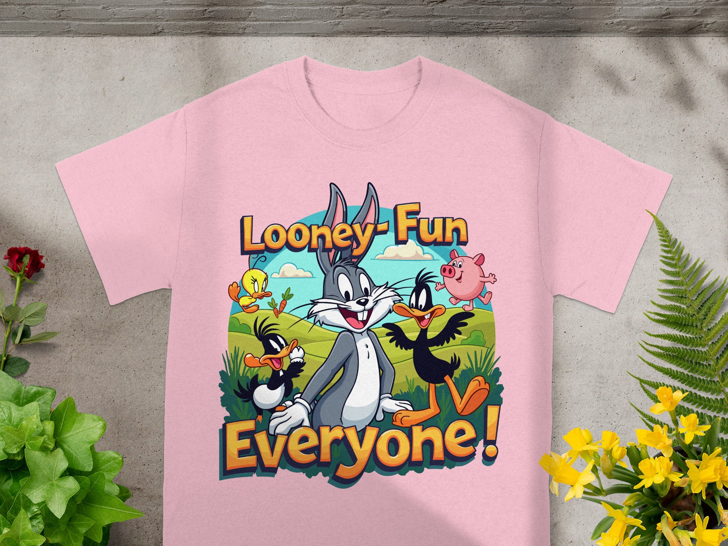 Looney Tunes characters Bugs Bunny, Daffy Duck, Tweety, and Porky Pig on a pink t-shirt.