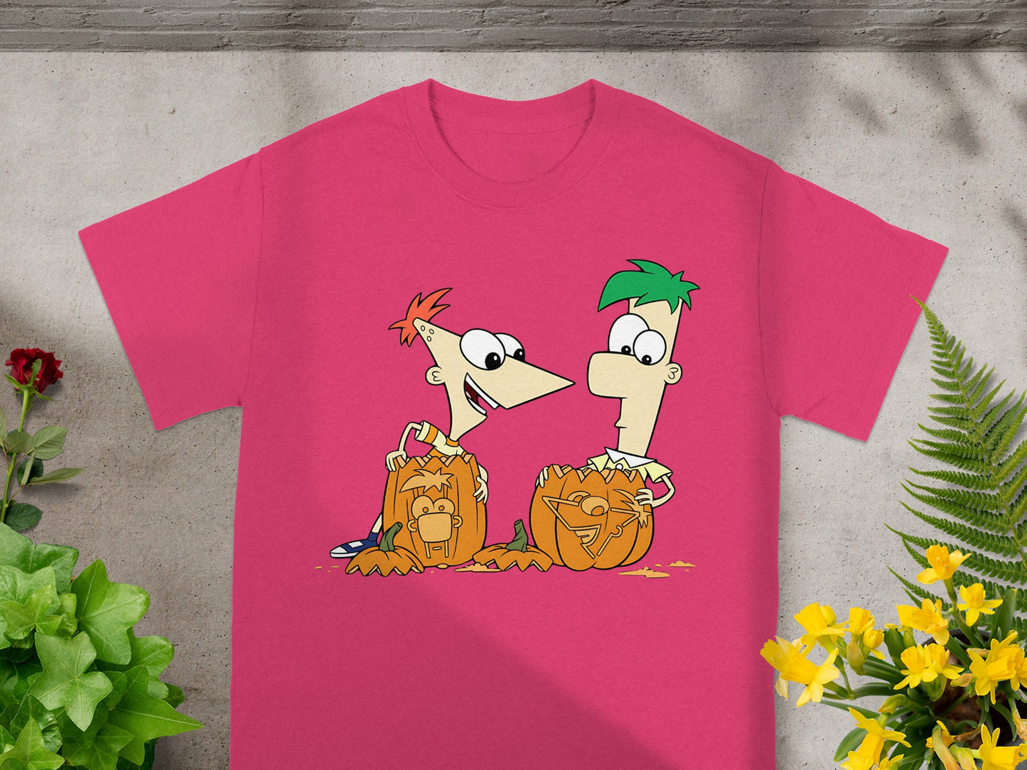 Phineas and Ferb carved pumpkins on a bright pink t-shirt.
