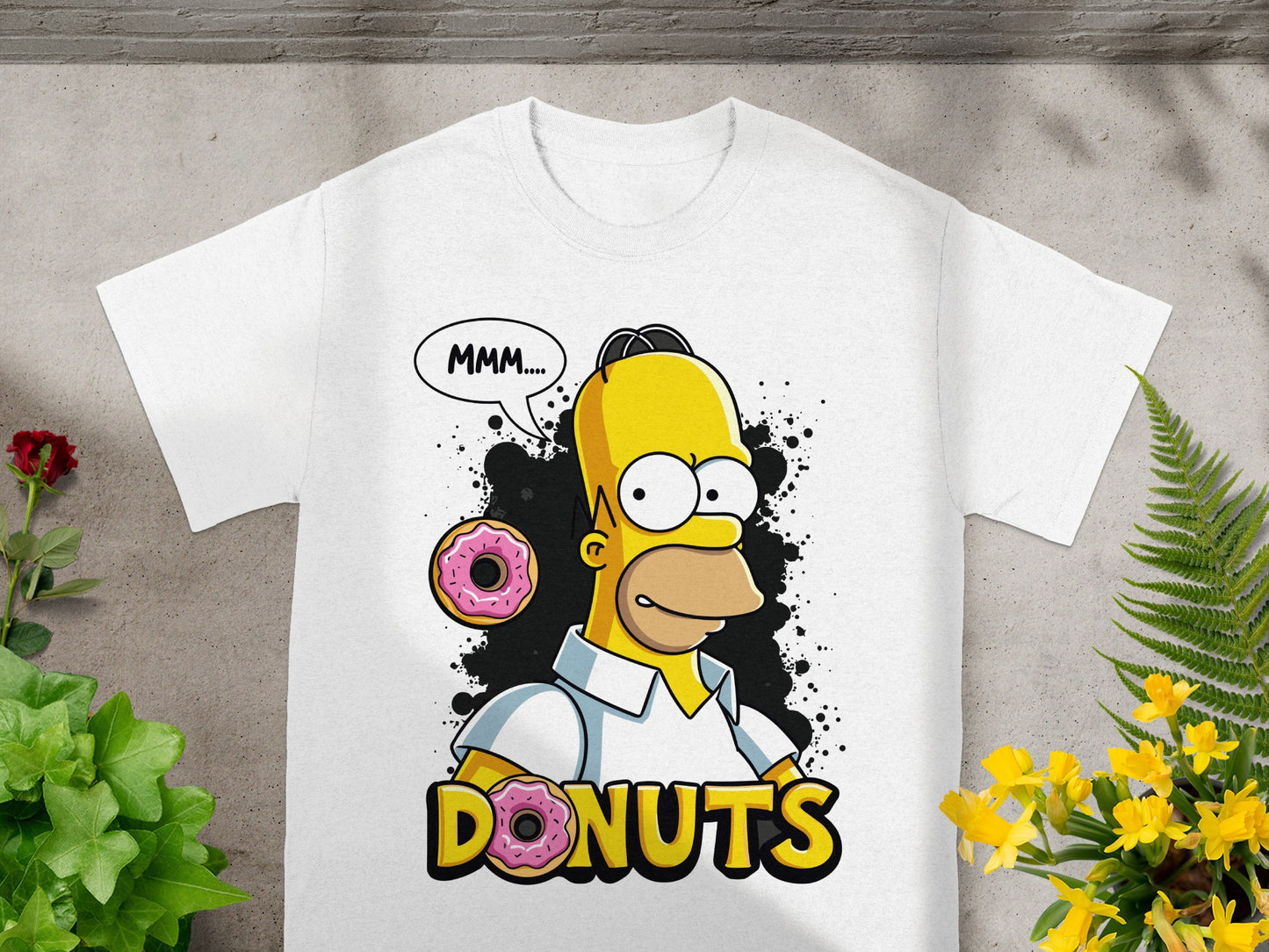 White t-shirt with Homer Simpson saying "MMM..." next to a donut.