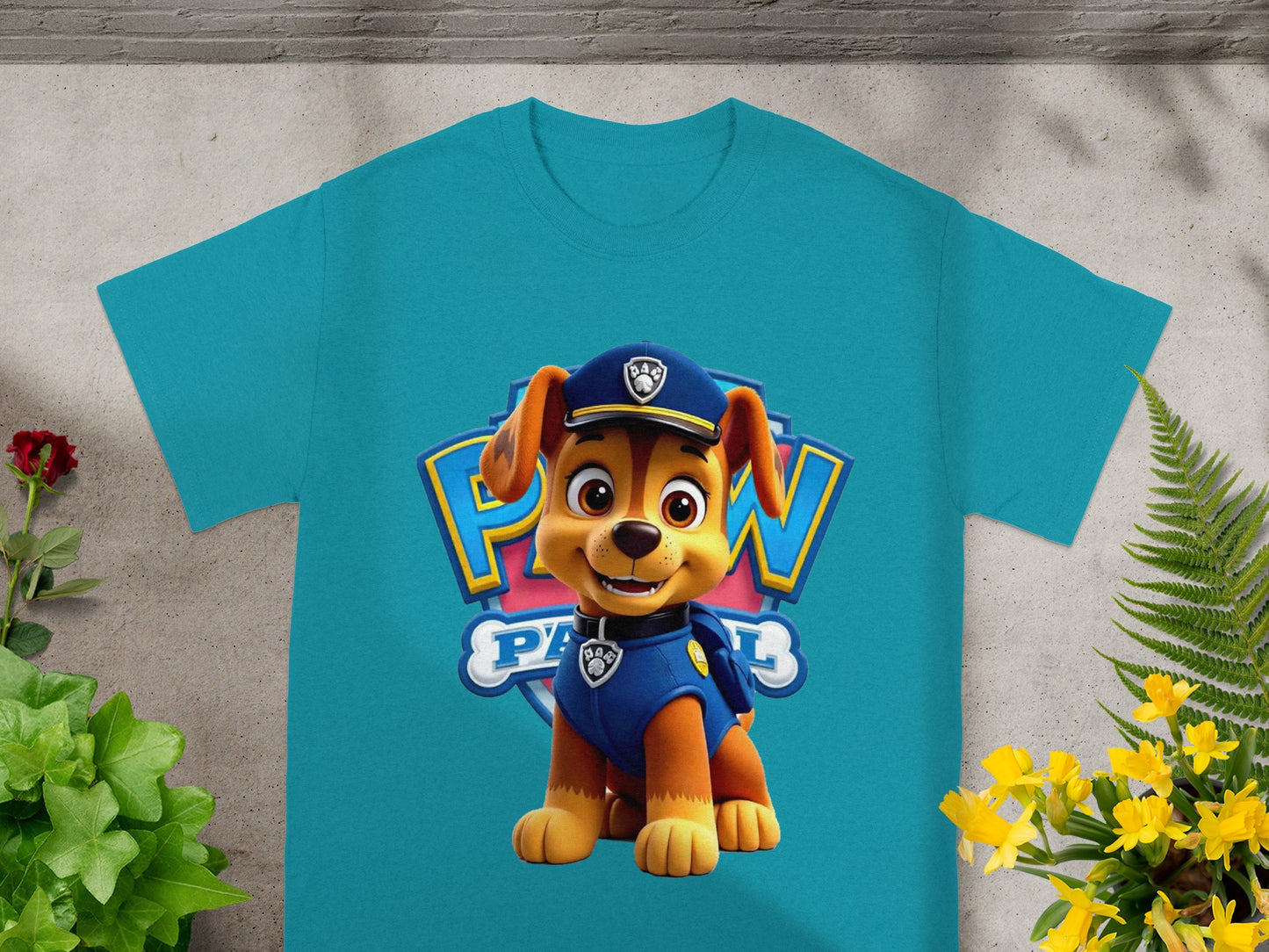 Chase from Paw Patrol on a teal t-shirt with a blue and yellow logo.