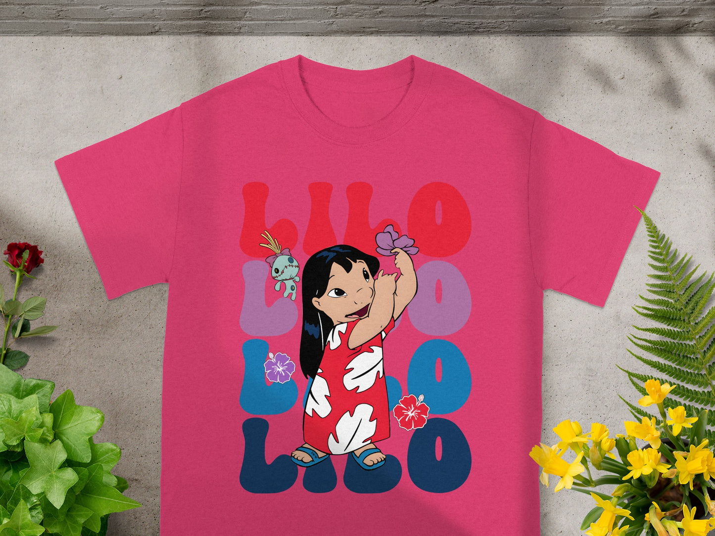 Pink t-shirt with Lilo and Stitch characters in colorful, bold lettering.