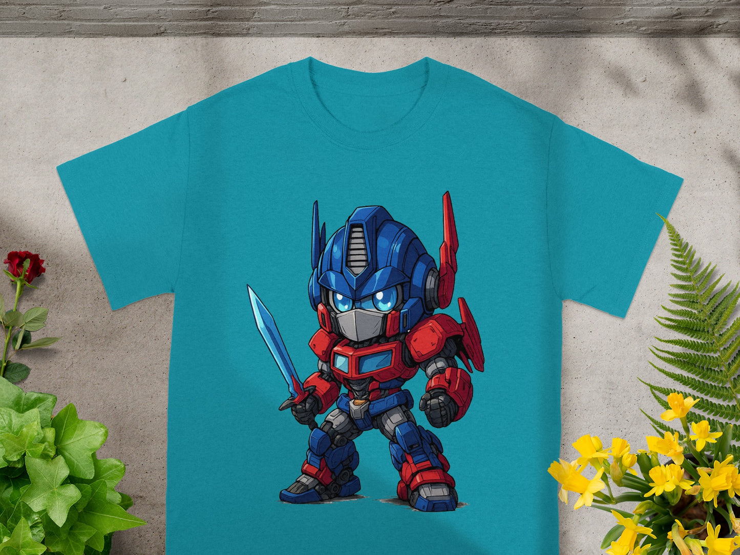 Chibi Optimus Prime holding a sword on a teal t-shirt.