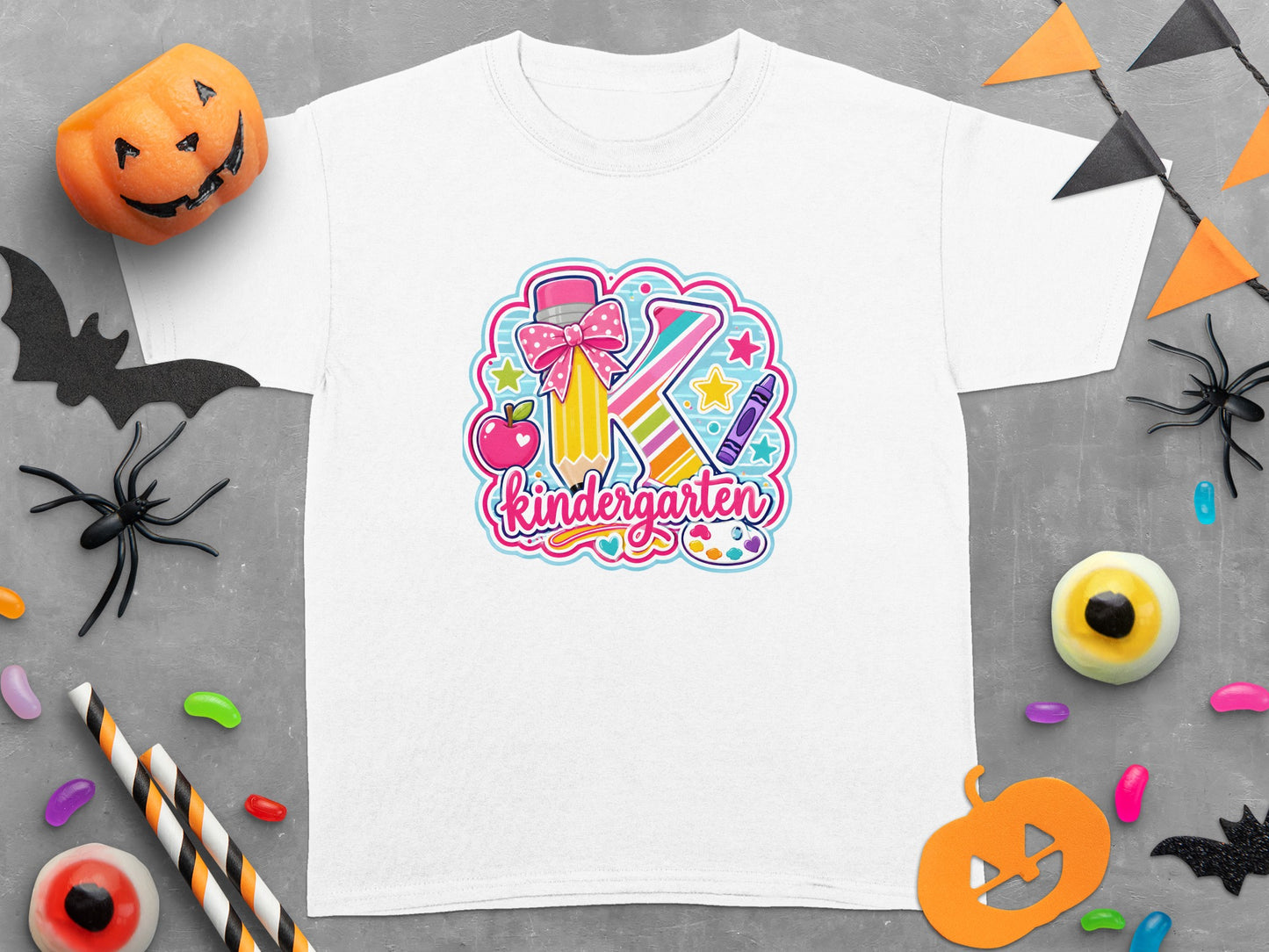 White t-shirt with graphic of letter K, pencil, apple, crayon, and text "Kindergarten."