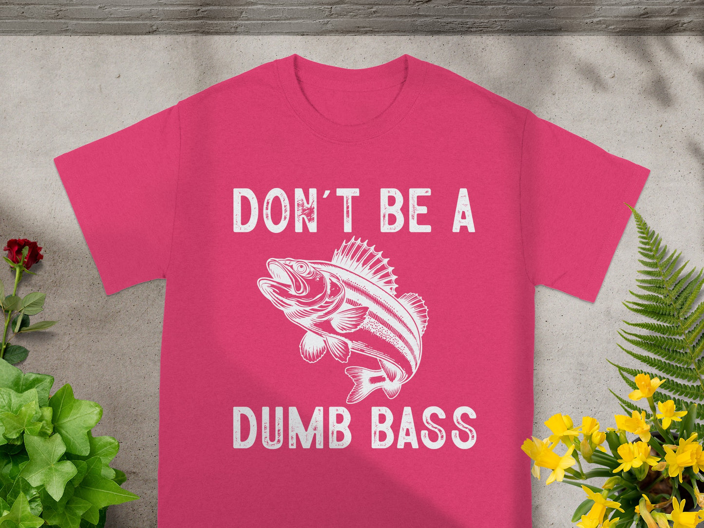 Pink t-shirt with white text and a fish graphic: "DON'T BE A DUMB BASS".