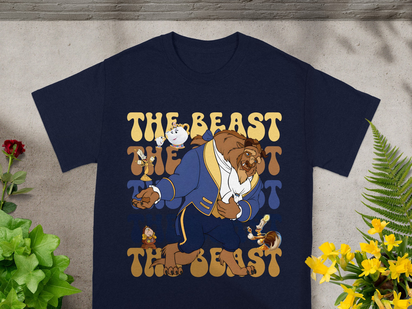 Navy t-shirt with "The Beast" in yellow and blue text and cartoon characters.