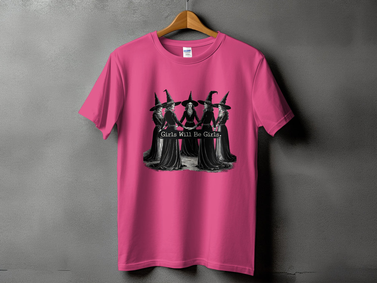 Pink t-shirt with graphic of five witches holding hands and text "Girls Will Be Girls."