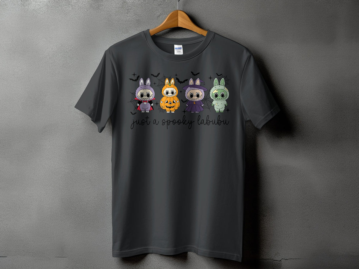 Dark grey t-shirt with four Halloween-themed cartoon labubus and "just a spooky labubu" text.